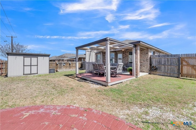 exterior space with an outbuilding, a fenced backyard, a wooden deck, and a storage shed