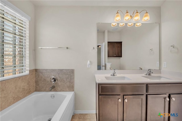 bathroom featuring tile patterned floors, a garden tub, a sink, and double vanity