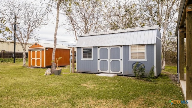 view of outbuilding with a yard