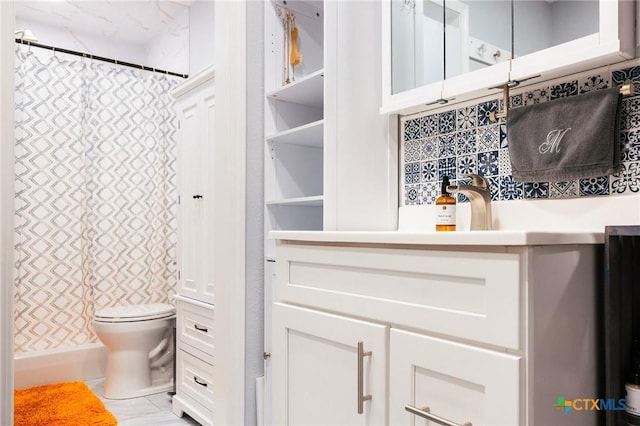 bathroom with tasteful backsplash and toilet