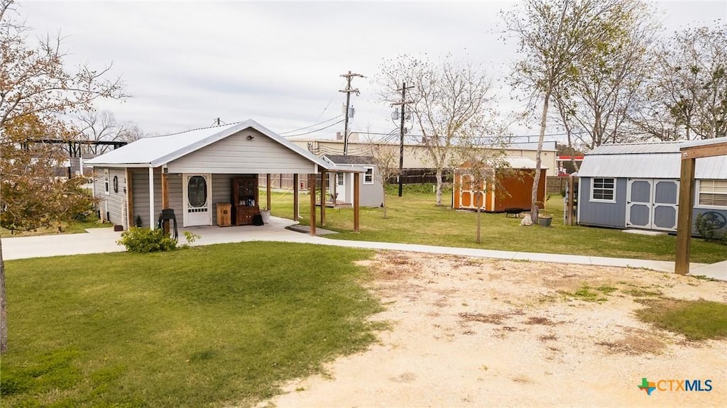 view of yard featuring a carport and a storage shed