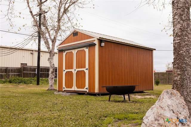 view of outbuilding with a yard