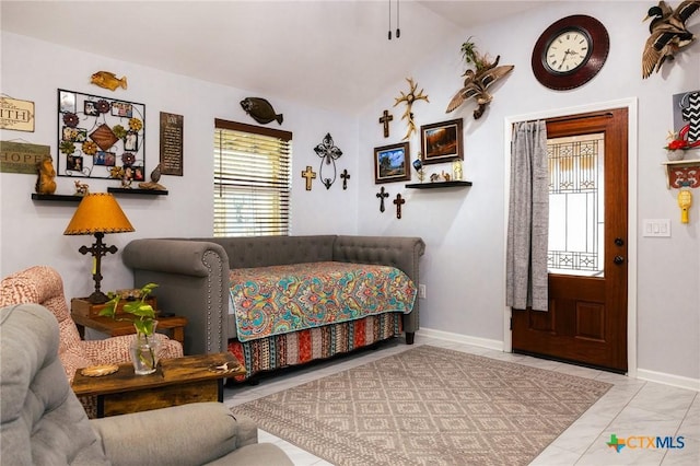 bedroom featuring light tile patterned floors and lofted ceiling