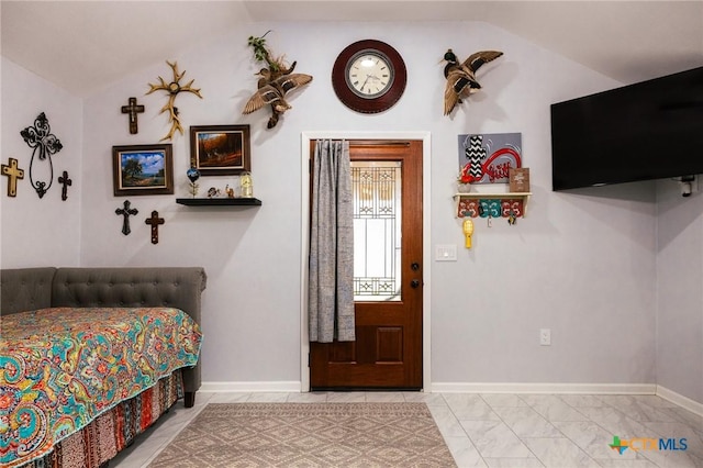 tiled bedroom featuring lofted ceiling