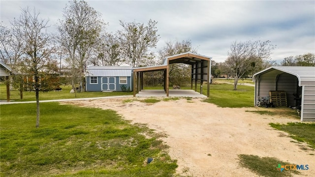 view of yard with an outdoor structure and a carport