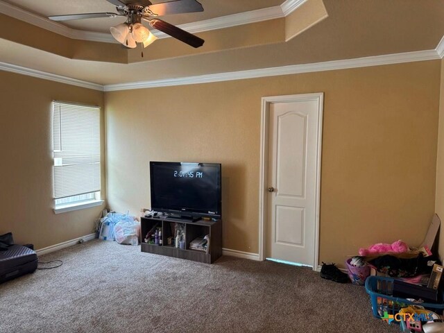 9604 Diana Dr, Killeen, TX 76542 - carpeted living area with a tray ceiling, a ceiling fan, ornamental molding, and baseboards