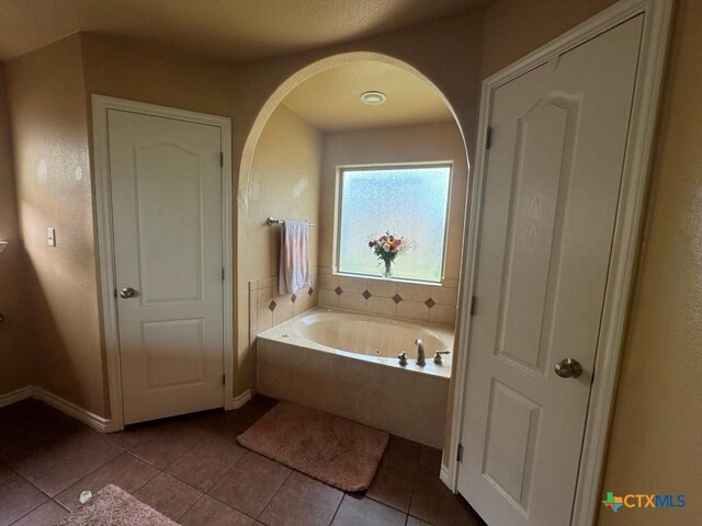 9604 Diana Dr, Killeen, TX 76542 - bathroom featuring tile patterned floors, a jetted tub, and baseboards