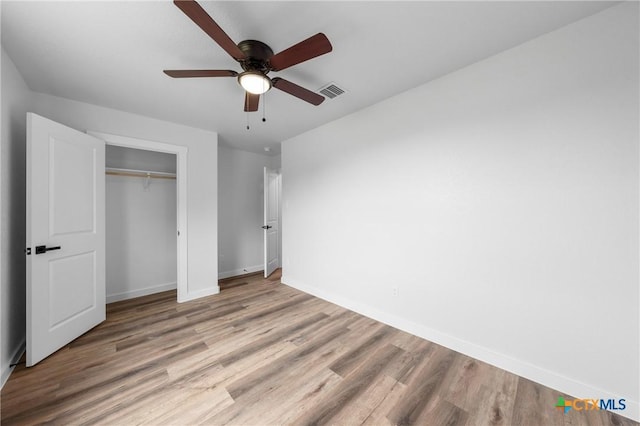 1005-1015 S 26th St, Temple, TX 76501 - unfurnished bedroom with baseboards, wood finished floors, a closet, and a ceiling fan