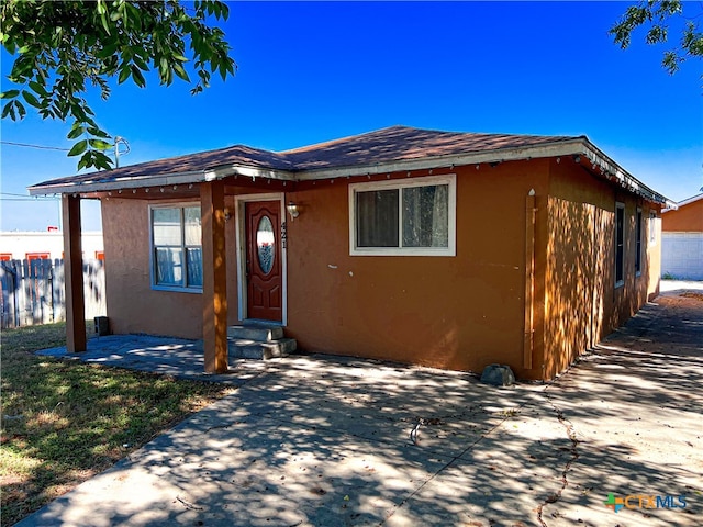 bungalow-style house with a patio area