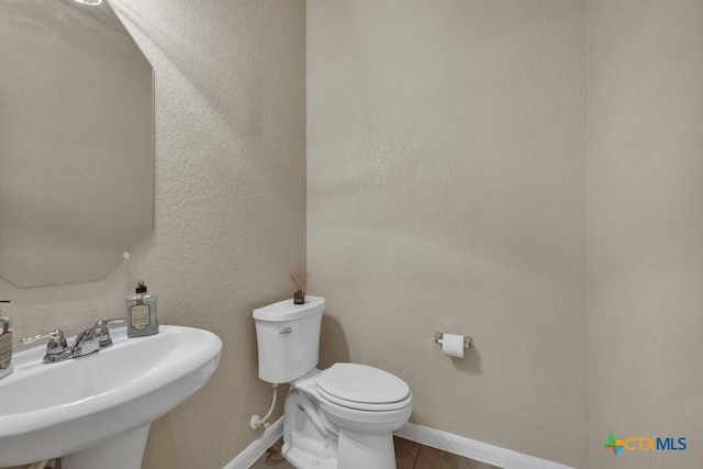 1104 Magellan, Windcrest, TX 78239 - bathroom featuring toilet, a sink, baseboards, and tile patterned flooring