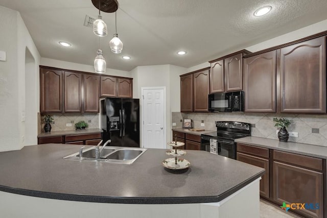 1104 Magellan, Windcrest, TX 78239 - kitchen featuring black appliances, a sink, dark countertops, a center island with sink, and backsplash