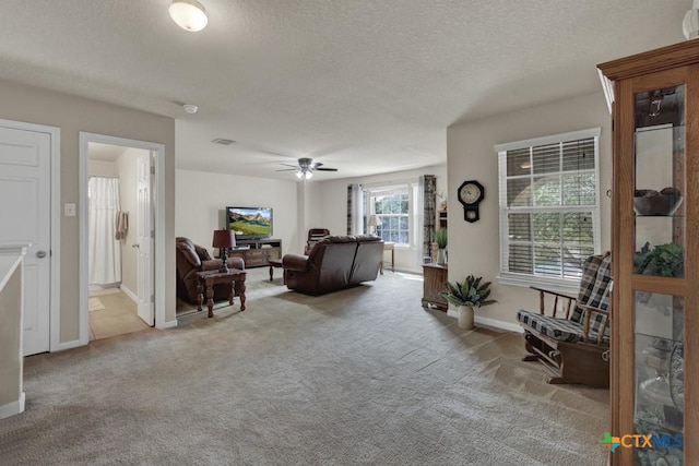 1104 Magellan, Windcrest, TX 78239 - carpeted living room with a textured ceiling, ceiling fan, and baseboards