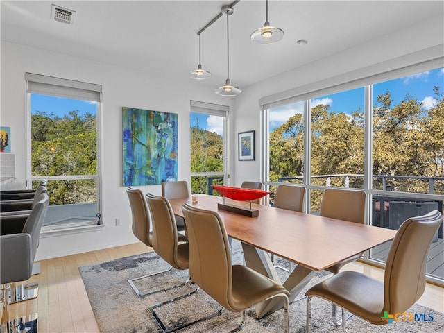 dining room with visible vents and wood-type flooring