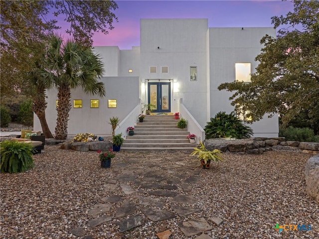 view of front of house featuring french doors and stucco siding