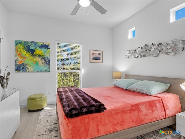 bedroom with baseboards, a ceiling fan, and wood finished floors