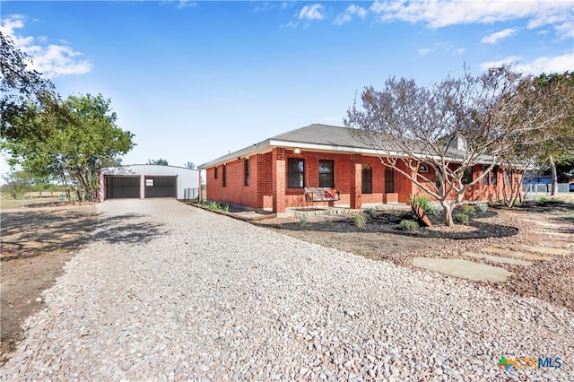 view of front facade with an outbuilding and a garage