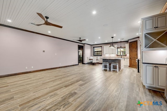 2147 Blue Ridge Dr, Canyon Lake, TX 78133 - unfurnished living room with ceiling fan, light wood-style floors, ornamental molding, baseboards, and recessed lighting