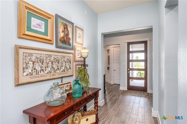 entrance foyer featuring wood finished floors and baseboards