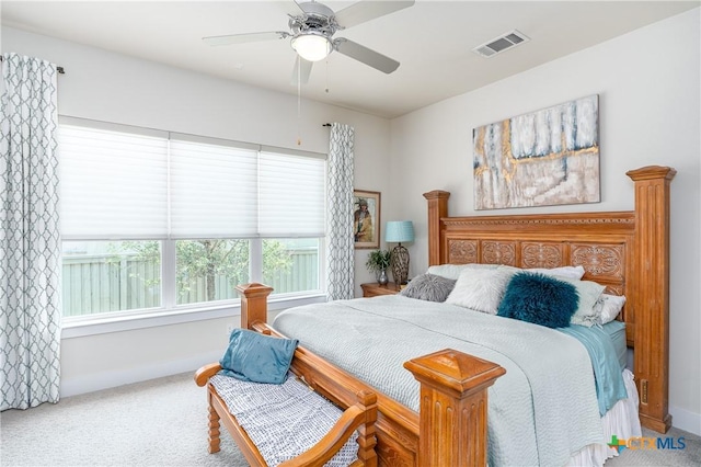 bedroom with carpet, visible vents, and a ceiling fan