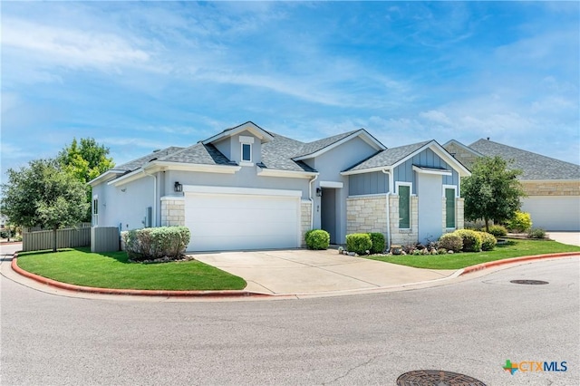 view of front facade with concrete driveway, an attached garage, fence, stone siding, and a front lawn