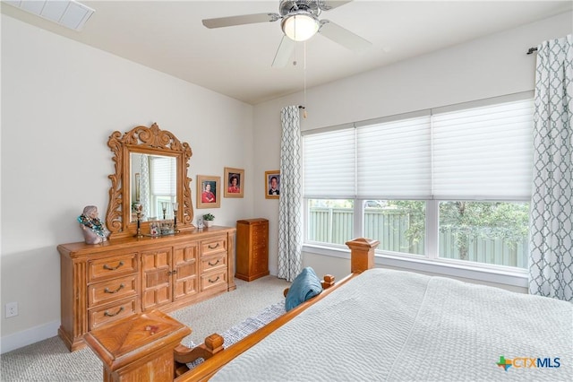 bedroom with multiple windows, visible vents, and carpet flooring