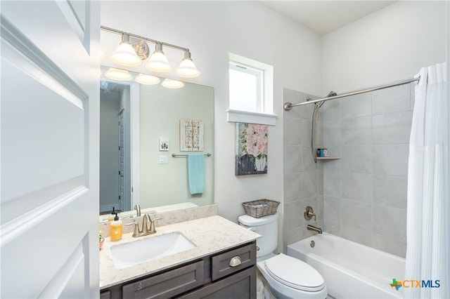 full bathroom with vanity, toilet, and shower / tub combo with curtain