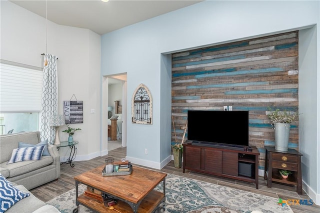 living room featuring wood finish floors and baseboards