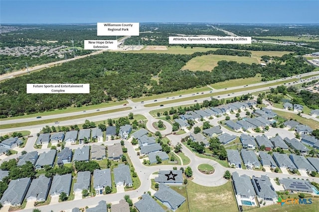 birds eye view of property with a residential view