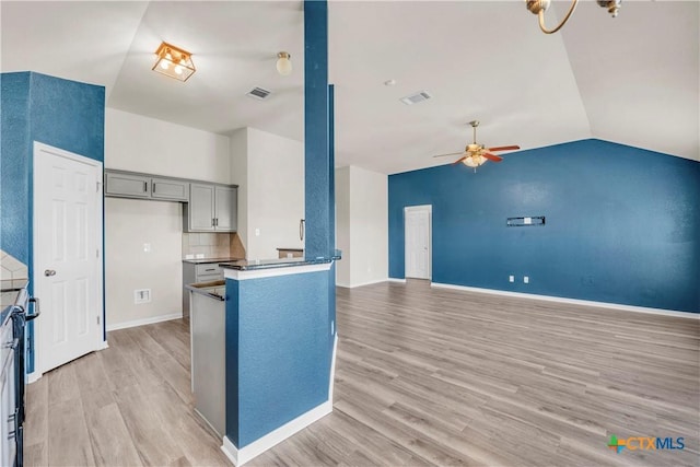 7810 Woodbury Dr, Temple, TX 76502 - kitchen with light wood-type flooring, ceiling fan, lofted ceiling, gray cabinets, and baseboards
