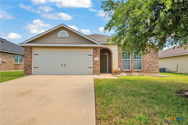 7810 Woodbury Dr, Temple, TX 76502 - view of front of home with concrete driveway, a front lawn, brick siding, and an attached garage