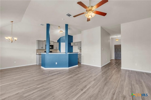 7810 Woodbury Dr, Temple, TX 76502 - unfurnished living room featuring ceiling fan, light wood finished floors, baseboards, a chandelier, and high vaulted ceiling