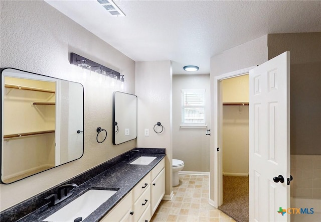 403 Ali Dr, Killeen, TX 76542 - bathroom featuring double vanity, toilet, and a walk in closet