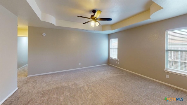 403 Ali Dr, Killeen, TX 76542 - unfurnished room with a tray ceiling, carpet flooring, ceiling fan, and baseboards