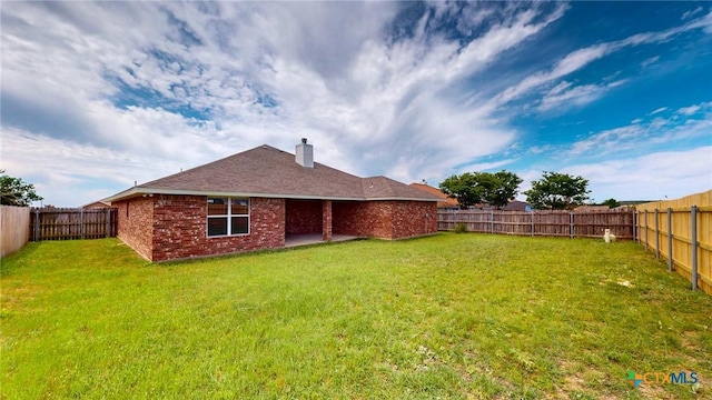 403 Ali Dr, Killeen, TX 76542 - back of house with brick siding, a chimney, and a patio area