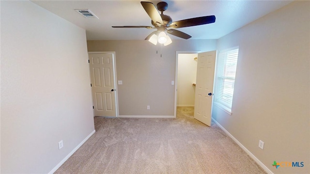 403 Ali Dr, Killeen, TX 76542 - unfurnished bedroom featuring light carpet, baseboards, and a ceiling fan