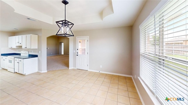 403 Ali Dr, Killeen, TX 76542 - kitchen with white range with electric cooktop, arched walkways, plenty of natural light, and baseboards