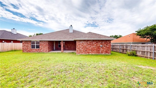 403 Ali Dr, Killeen, TX 76542 - back of house featuring a patio, a chimney, brick siding, and roof with shingles