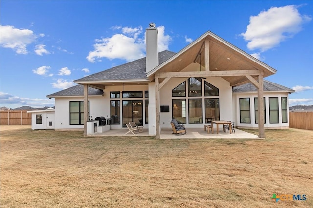 back of house featuring a patio and a lawn