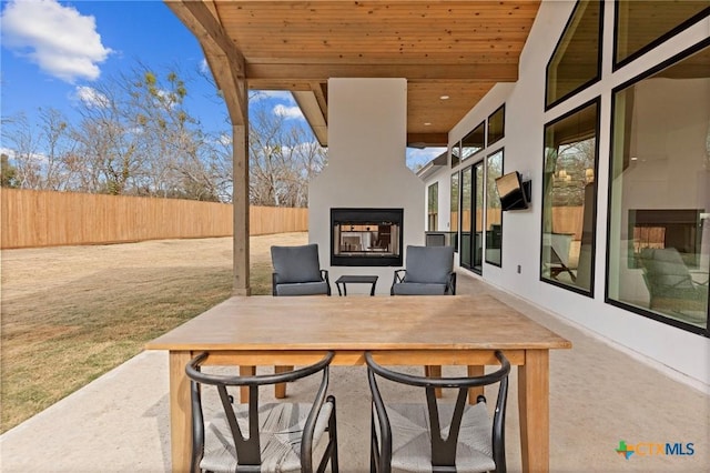 view of patio featuring a multi sided fireplace