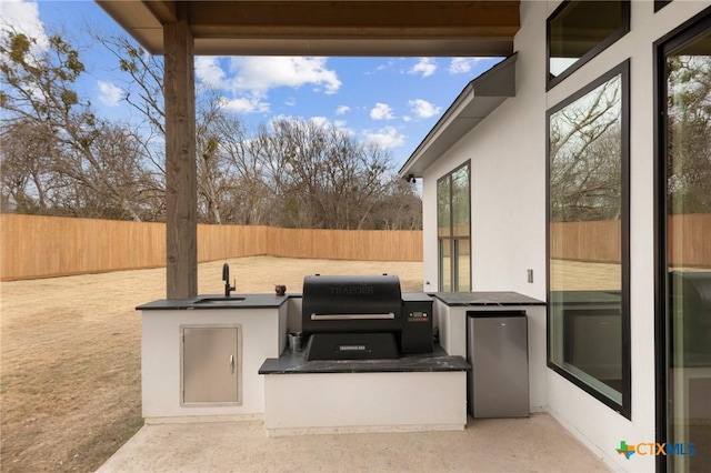 view of patio / terrace with grilling area, exterior kitchen, and sink