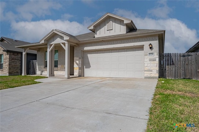 view of front of property featuring a garage, brick siding, fence, stone siding, and concrete driveway