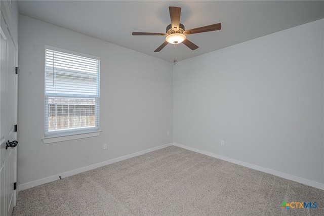 unfurnished room with carpet flooring, ceiling fan, and baseboards