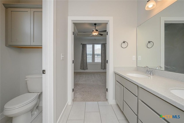 full bath featuring tile patterned floors, a sink, toilet, and double vanity