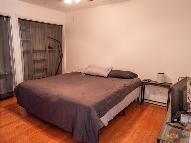 bedroom featuring a textured ceiling, light hardwood / wood-style flooring, and pool table