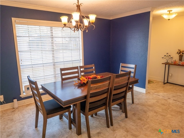 dining room with a chandelier, a textured ceiling, and ornamental molding