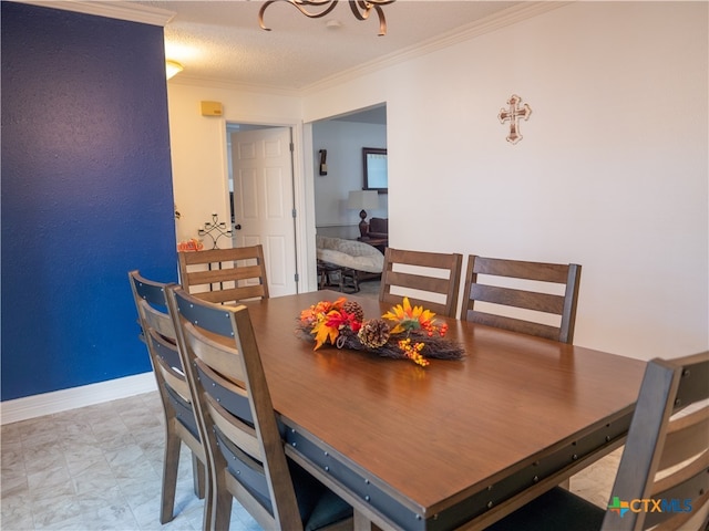 dining area with ornamental molding and a textured ceiling