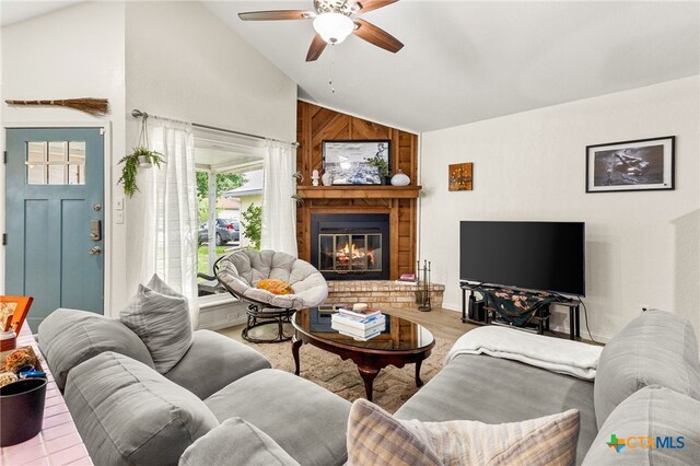 922 Sundance St, New Braunfels, TX 78130 - living area featuring a ceiling fan, a glass covered fireplace, wood finished floors, and high vaulted ceiling