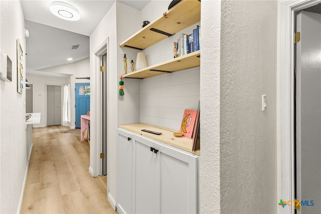mudroom featuring light wood finished floors and visible vents