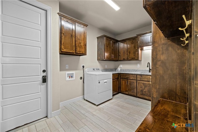 813 Reston Rd, Temple, TX 76502 - washroom featuring washer / dryer, cabinet space, and light wood-type flooring