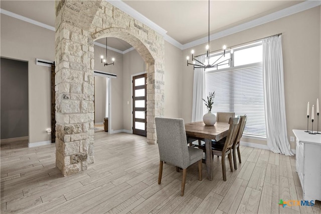 813 Reston Rd, Temple, TX 76502 - dining space with ornamental molding, arched walkways, a chandelier, light wood finished floors, and healthy amount of natural light
